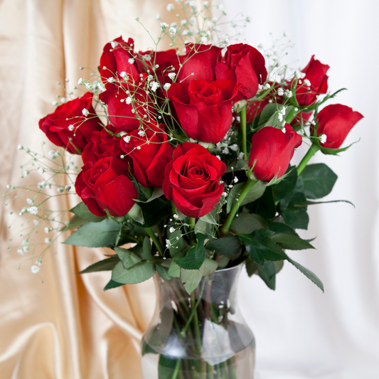 Red roses arranged in a vase.